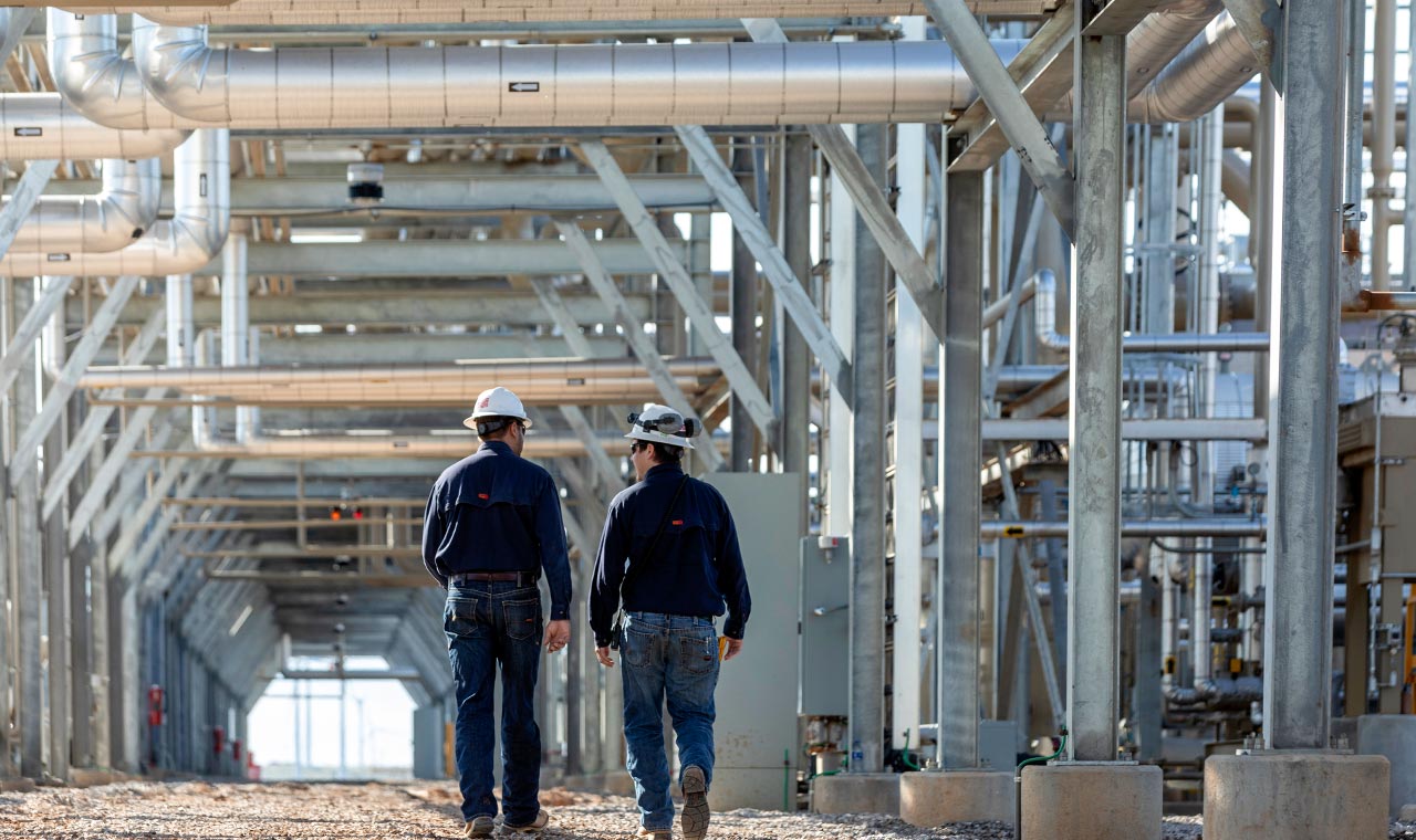 Two Blue Mountain Midstream Workers Working Through a Midstream Plant
